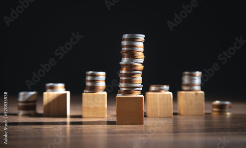 Stack of coins and empty wooden cubes on the table. Business. Finance