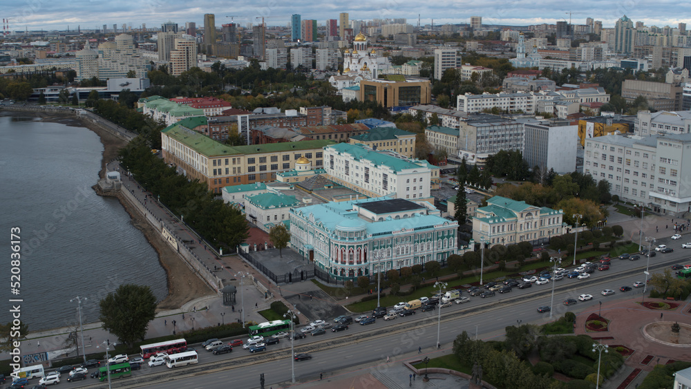 A beautiful big city from a bird's-eye view.Stock footage. The bright city of Yekaterinburg, the city center with high-rise buildings, a river and large houses.