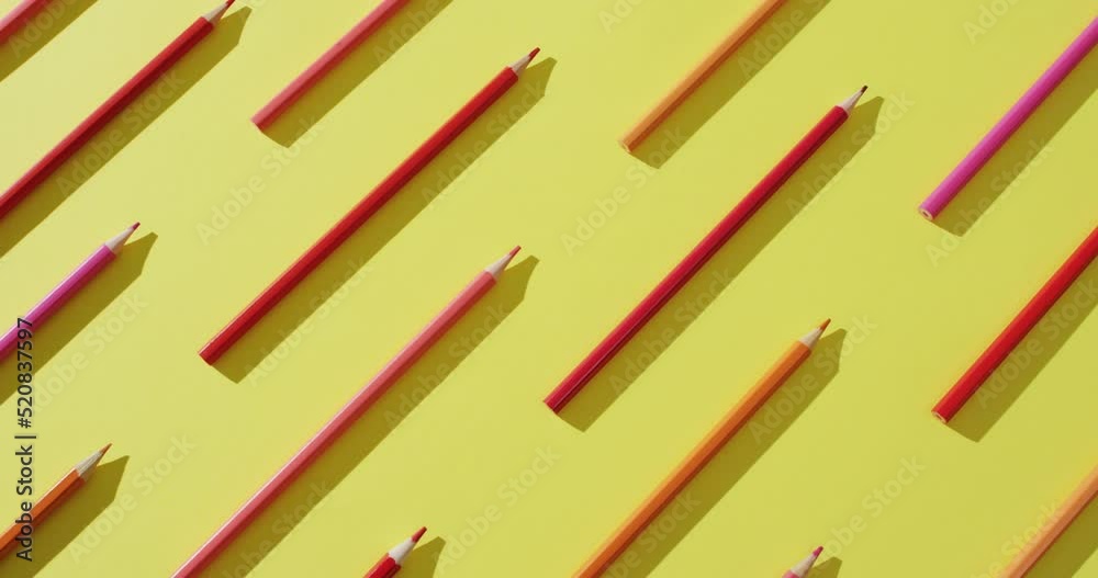 Video of multi-colored crayons in a row on a yellow background Video of multi-colored crayons in a row on a yellow background
