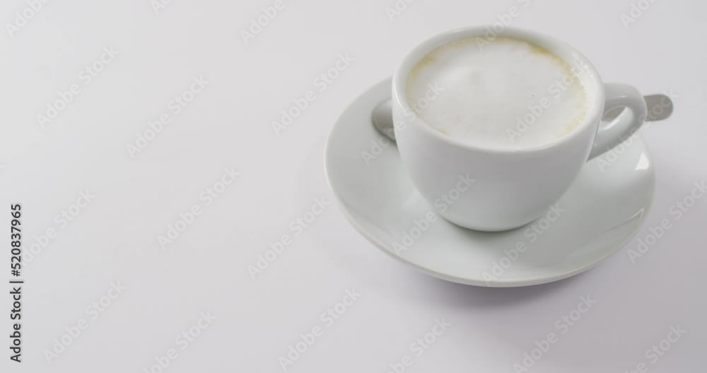 Video of white cup of coffee with milk over white background Video of white cup of coffee with milk over white background