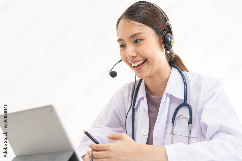 Doctor or physician wearing white coat, stethoscope using headset, consulting health by telehealth online for speaking video call consultation on tablet. Telemedicine by medical for distance patient. Doctor or physician wearing white coat, stethoscope using headset, consulting health by telehealth online for speaking video call consultation on tablet. Telemedicine by medical for distance patient.