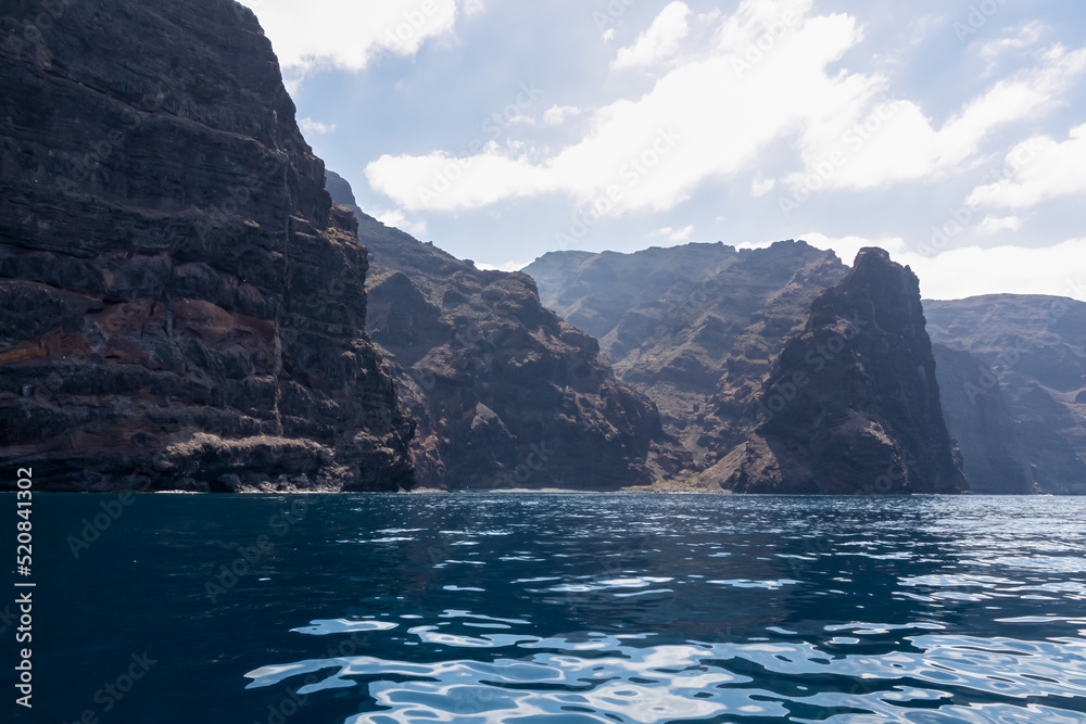 Panoramic view on the massive cliffs of Los Gigantes in Santiago del Teide, Western coast of Tenerife, Canary Islands, Spain, Europe. Rock formations along the coastline of the Atlantic Ocean. Freedom