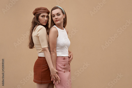 Obraz na płótnie Young beautiful models dressed in retro vintage style enjoying the old european city summertime lifestyle. Old fashioned clothes. w salonie