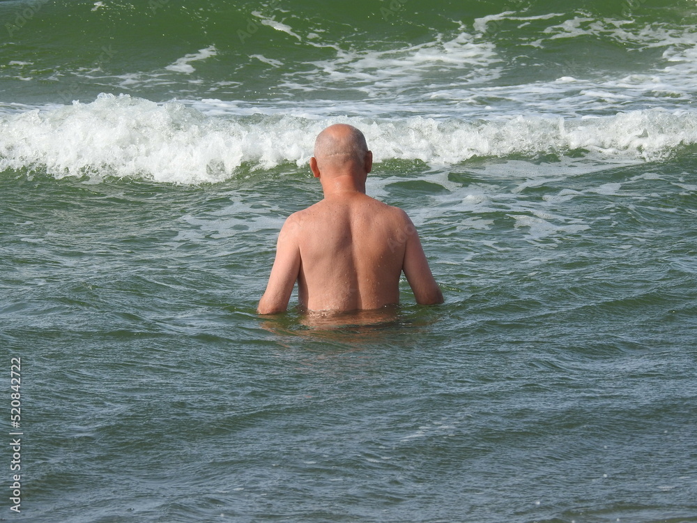 bald old man in sea waves bald old man in sea waves