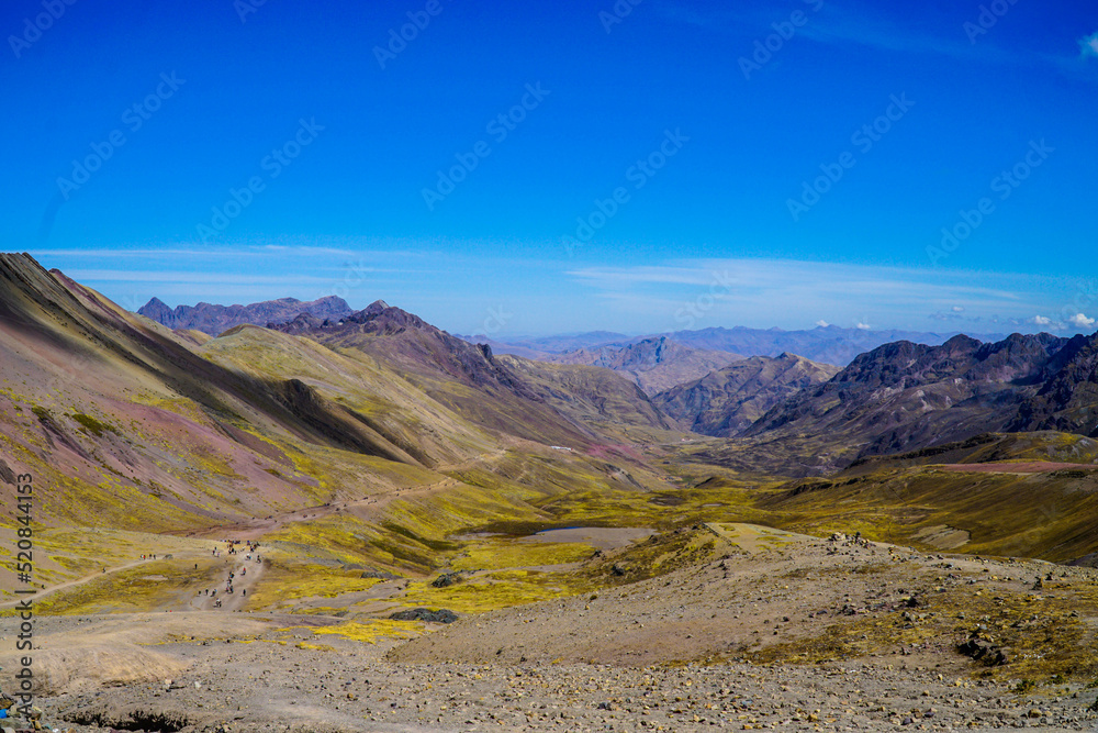 Unidentified tourists walking on the Rainbow Mountain (Vinicunca Montaña de Siete Colores - Spanish) in Cusco, Peru