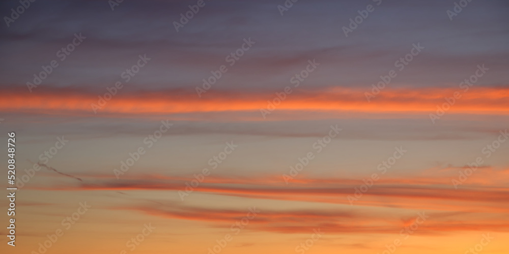 Bright sunset sky, full frame. Orange, pink, red clouds. The sky as a background.