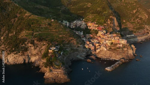 View from above, stunning aerial view of Manarola, the second village of the Cinque Terre coming from La Spezia. Manarola is the most picturesque village, made up of colorful tower-houses. photo