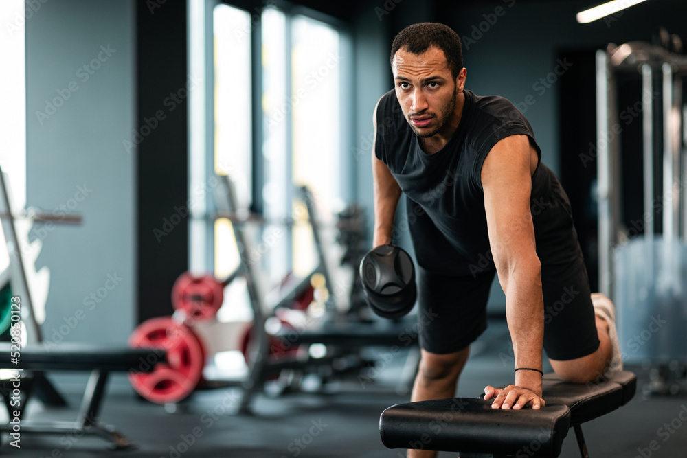 Gym Workout. Muscular African American Man Training With Dumbbell In Sport Club Gym Workout. Muscular African American Man Training With Dumbbell In Sport Club