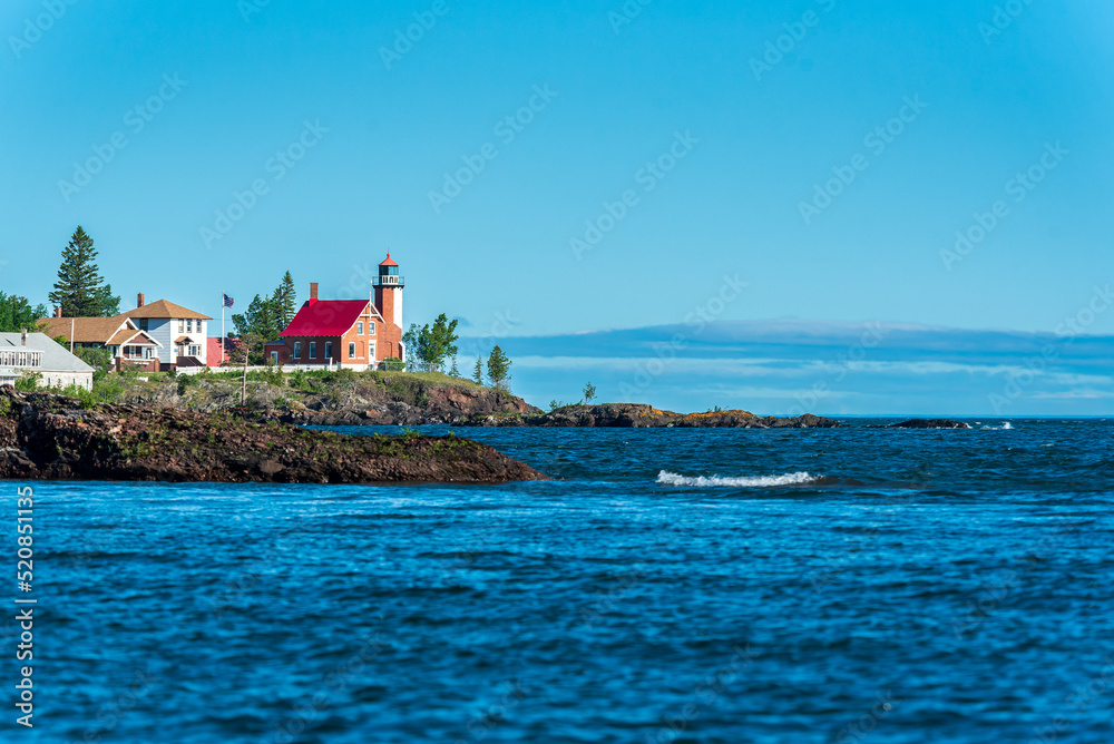 Eagle Harbor Lighthouse stands above a rocky entrance to Eagle Harbor