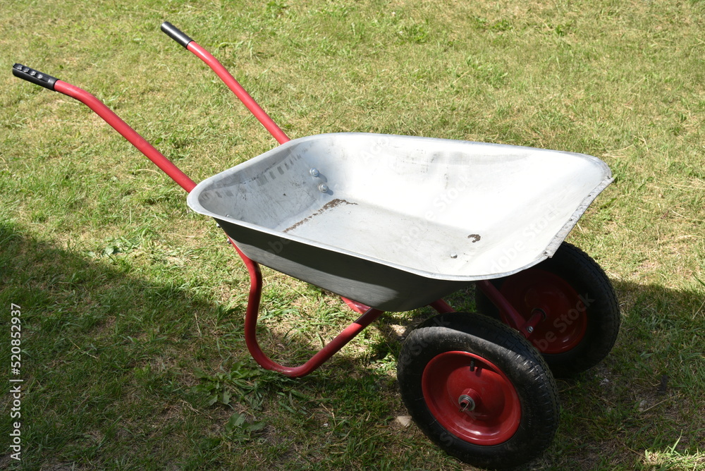 An empty garden iron cart in a summer park An empty garden iron cart in a summer park