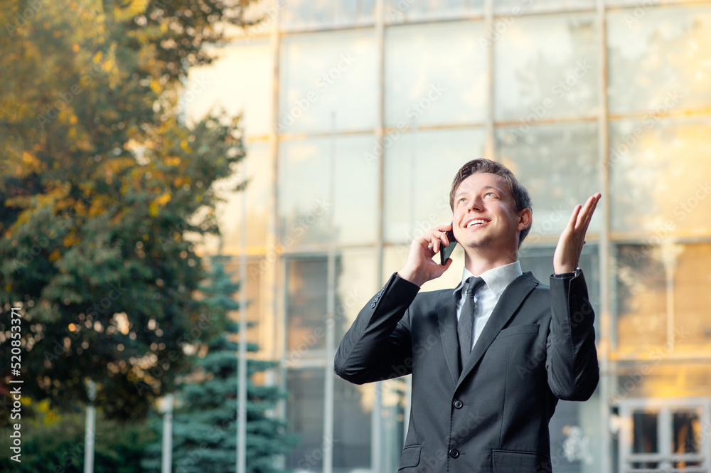 young business man talking on the mobile phone young business man talking on the mobile phone