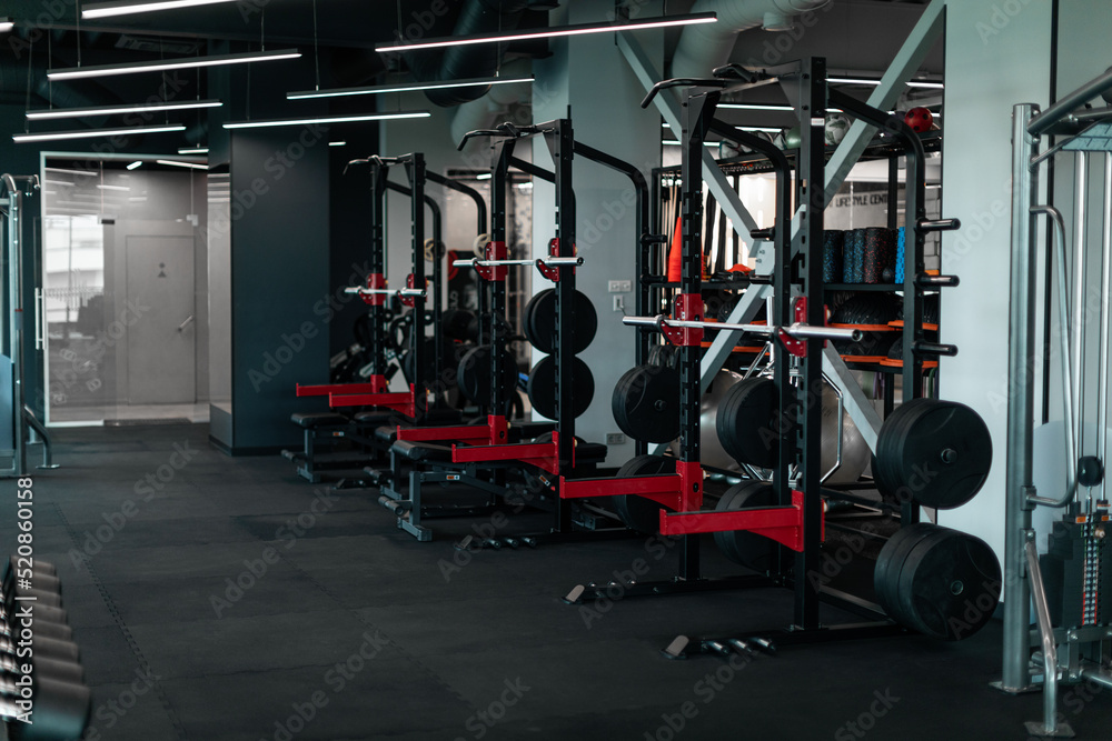 Heavy Weight Lifting Equipment Standing In A Row In Empty Gym, Heavy Weight Lifting Equipment Standing In A Row In Empty Gym,