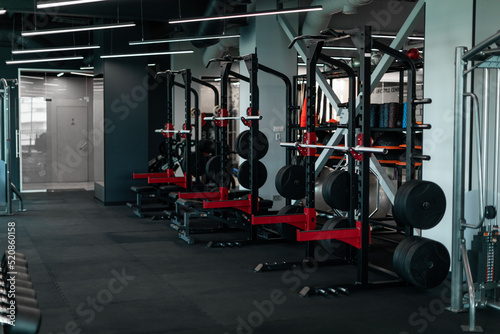 Heavy Weight Lifting Equipment Standing In A Row In Empty Gym,