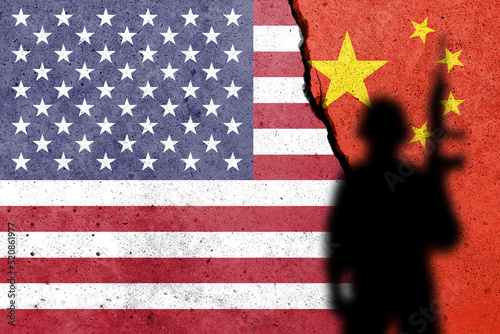 Photography United States of America and China flags painted on the concrete wall with soldier shadow