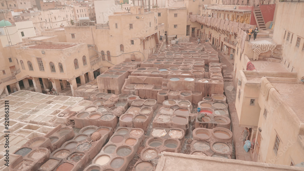 Old factory in Morocco. Action. Top view of tannery or dye shop in old town. Clay houses and old dye house in Morocco