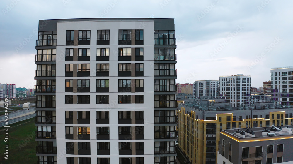 Fototapeta premium Top view of beautiful residential area with modern buildings. Stock footage. Beautiful residential area on sunny summer day. Modern residential buildings in well-maintained area of city