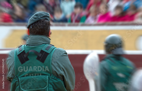 A Guardia Civil officer observes his colleagues wearing anidisturve helmets. photo