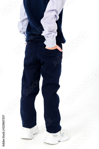 School uniform, black pants with pockets, back view