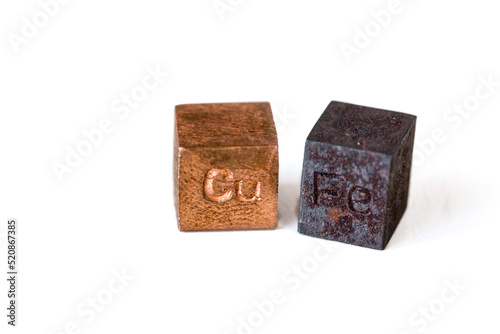 Iron and copper cubes with elements names on them on pure white background