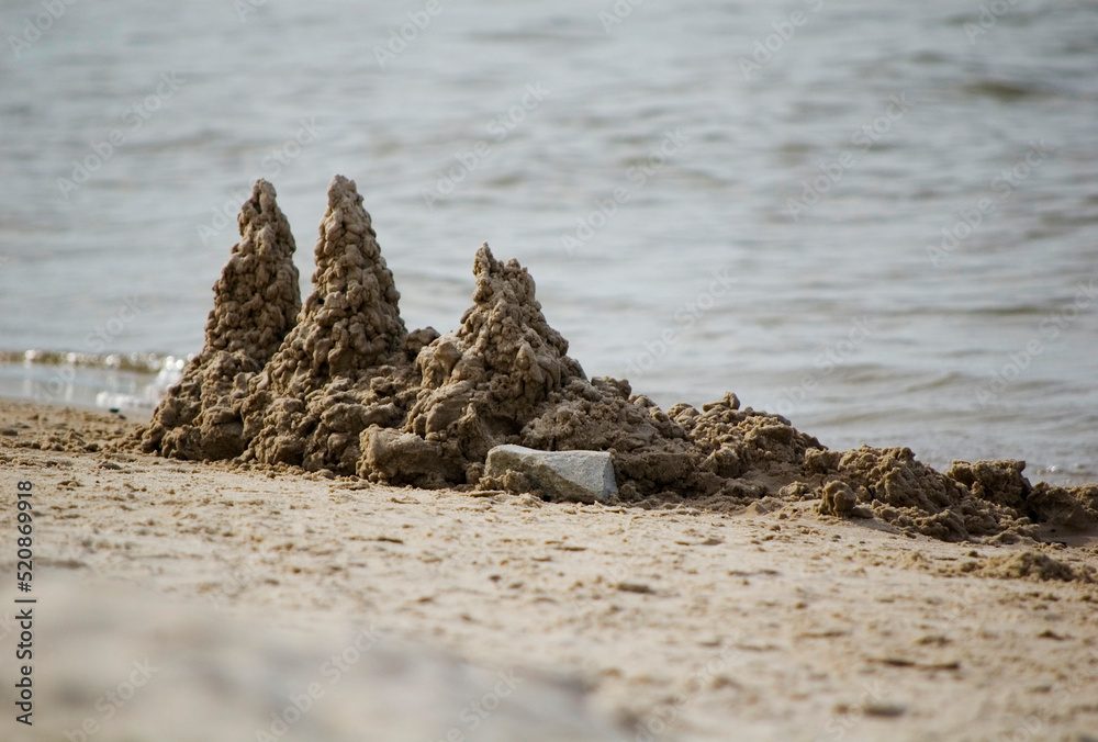 View of the sand building on the seashore. Selective focus.