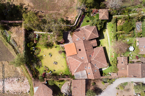 Aerial view of a rural house in the countryside of Cusco Peru. House in Yucay town with roof tiles.