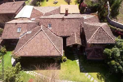 Aerial view of a rural house in the countryside of Cusco Peru. House in Yucay town with roof tiles. photo