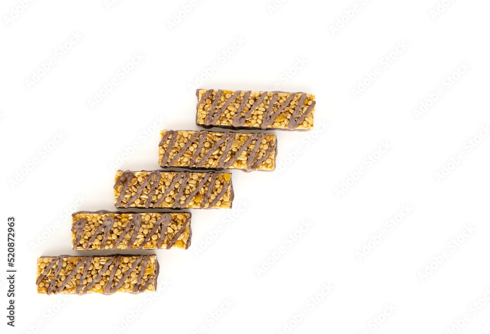 Five popcorn bars with chocolate and caramel are arranged in steps on a white background. Fast food concept.