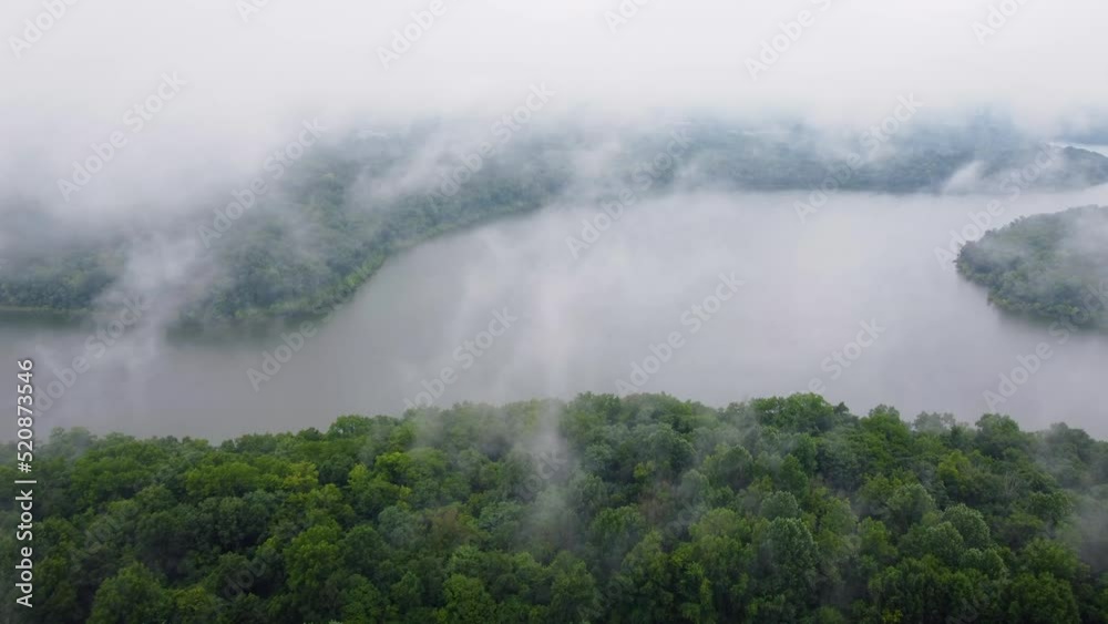 Approaching and flying through low clouds over forests around Taylorsville lake in Kentucky Approaching and flying through low clouds over forests around Taylorsville lake in Kentucky
