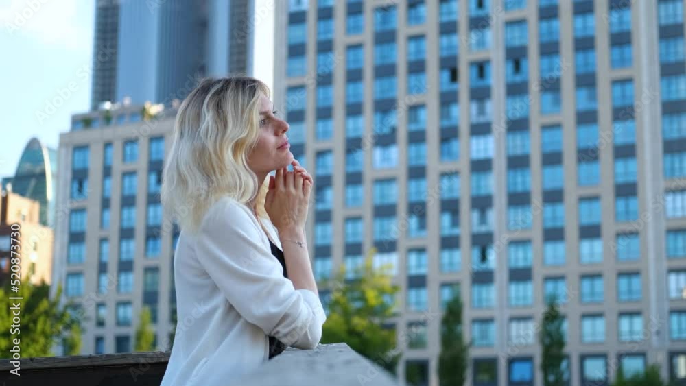 portrait of a charming blonde woman against the backdrop of skyscrapers portrait of a charming blonde woman against the backdrop of skyscrapers