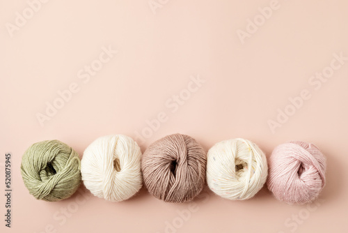 Craft hobby background with yarn in natural colors. Recomforting hobby to reduce stress for cold fall and winter weather. Mock up, copy space, top view