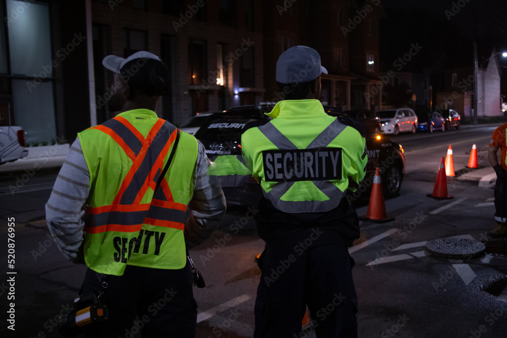 Security guard in car patroling at construction site at night city Security guard in car patroling at construction site at night city