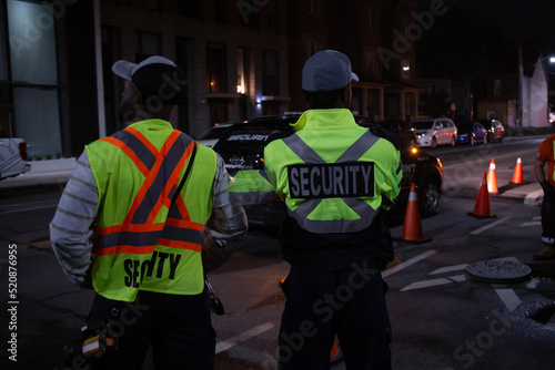Security guard in car patroling at construction site at night  city