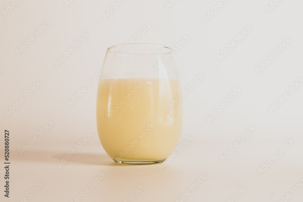 glass of milk on white table, white background glass of milk on white table, white background