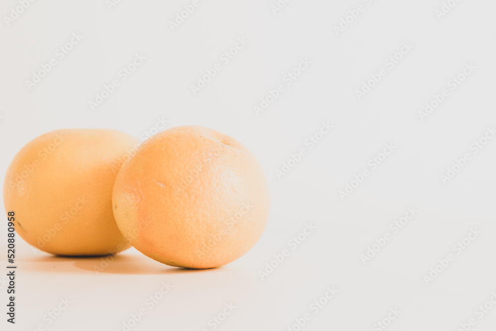 pink grapefruits on white table pink grapefruits on white table