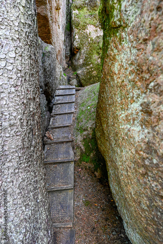 wooden steps on trail between big rocks