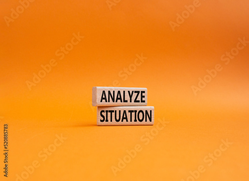 Analyze situation symbol. Wooden blocks with words Analyze situation. Beautiful orange background. Business and Analyze situation concept. Copy space.