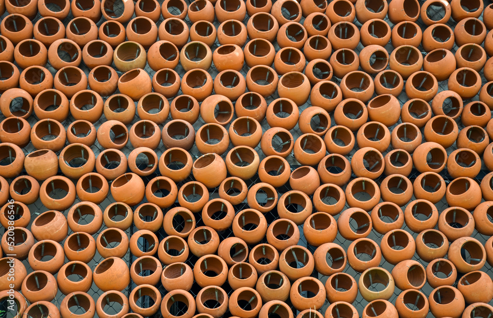 Texture or background of brown round clay pots on the wall Texture or background of brown round clay pots on the wall