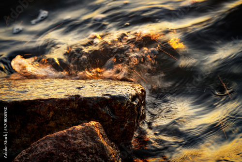 Small wave, stone and light reflection background