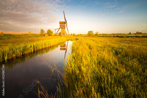 dutch windmill broekmolen at sunrise. Kinderdijk - Unesco.