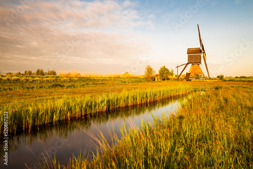 dutch windmill broekmolen at sunrise. Kinderdijk - Unesco.