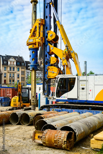 Global project of urban re-development: drilling machine at work on a building site