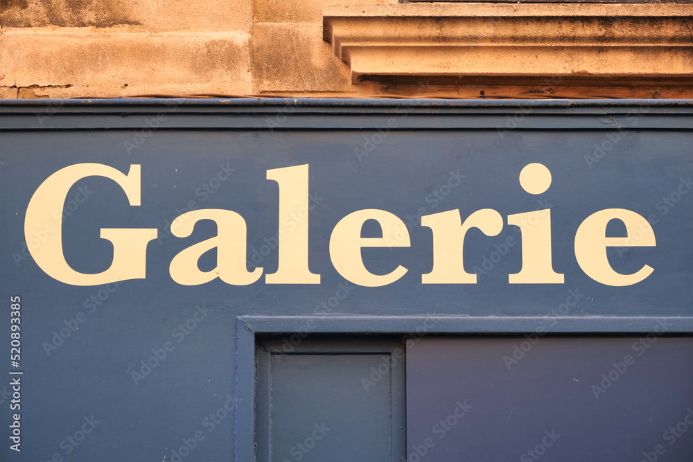 Letters above a store say 'Galerie' which means gallery in English. Beautiful billboard store sign lettering. Old style letters. 