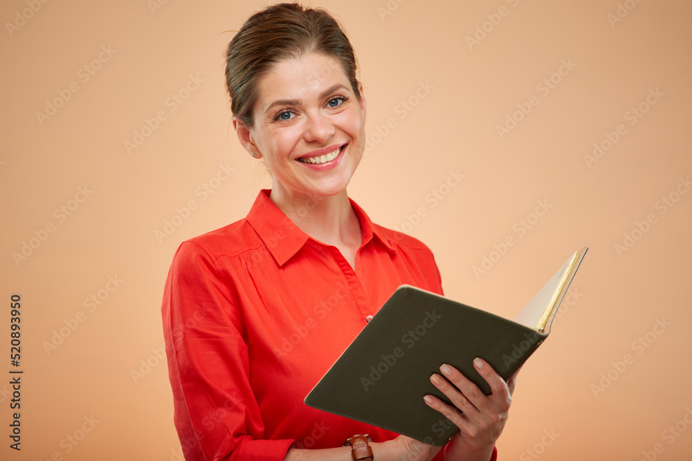 Smiling teacher or student in red shirt with open book isolated portrait. Smiling teacher or student in red shirt with open book isolated portrait.