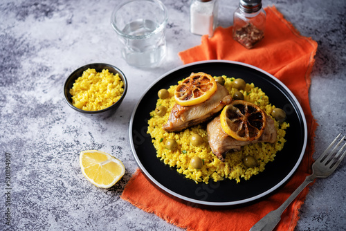 Moroccan fried chicken breast with curry rice in a plate