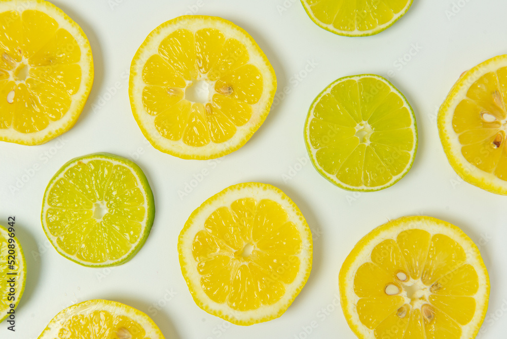 Fresh cut lemon and lime slices on white background