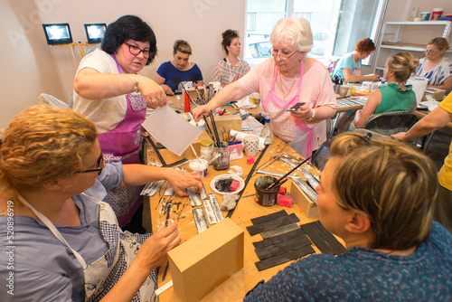 Women in art workshop making decoupage boxes