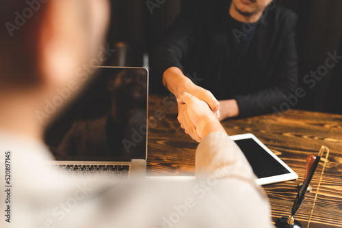 Hands of two male business ...