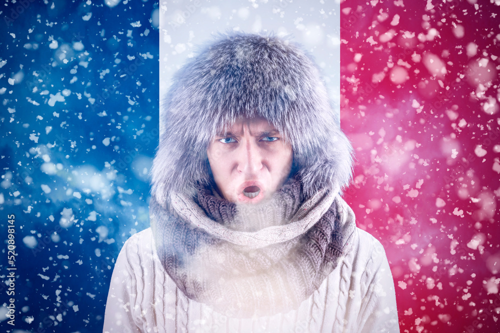 Isolate. Cold weather. Bask. A man in a fur hat and scarf warms his hands with his mouth. It's winter time Isolate. Cold weather. Bask. A man in a fur hat and scarf warms his hands with his mouth. It's winter time