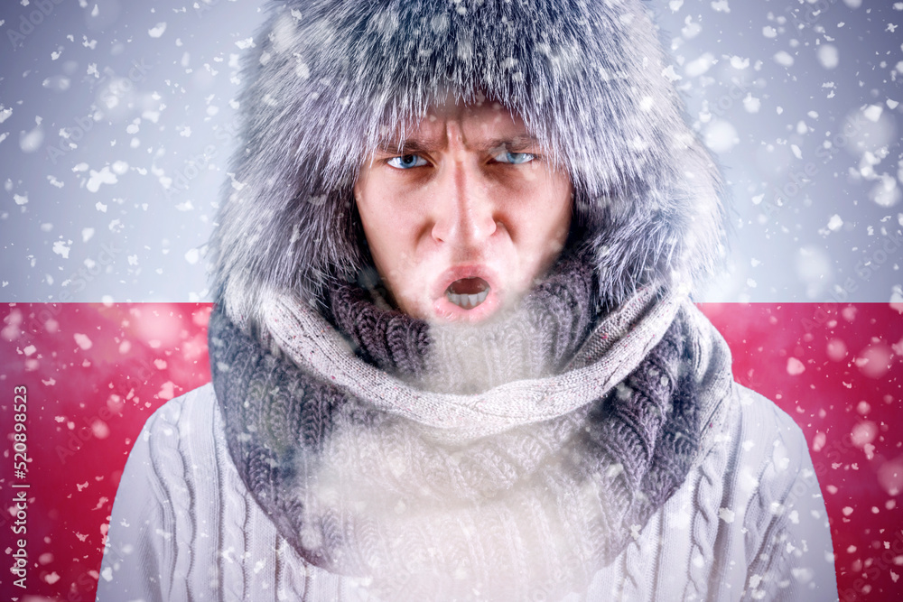 Isolate. Cold weather. Bask. A man in a fur hat and scarf warms his hands with his mouth. It's winter time Isolate. Cold weather. Bask. A man in a fur hat and scarf warms his hands with his mouth. It's winter time