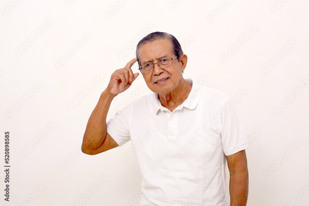 Fototapeta premium Smart asian old man standing while touching head. Isolated on white background